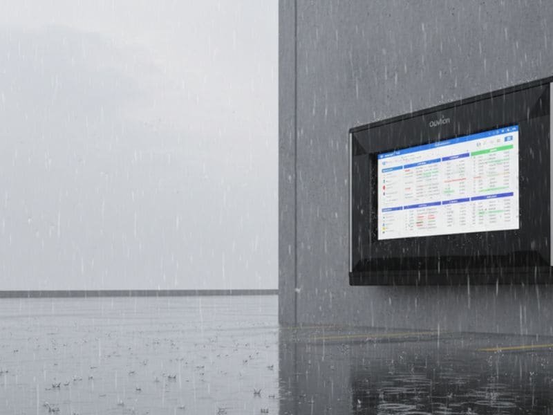 Industrial Monitor Enclosures for outdoor logistics dashboard in heavy rain at warehouse loading area